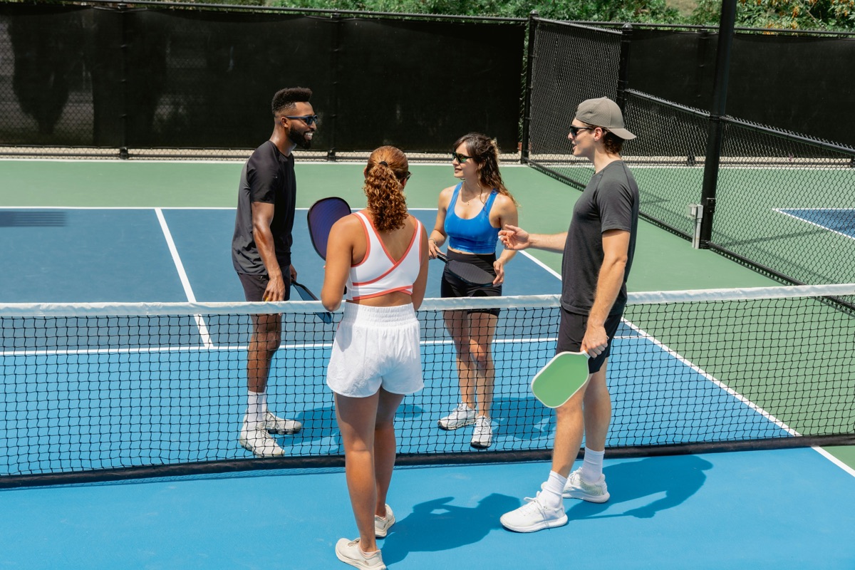 People meeting on an outdoor sports court